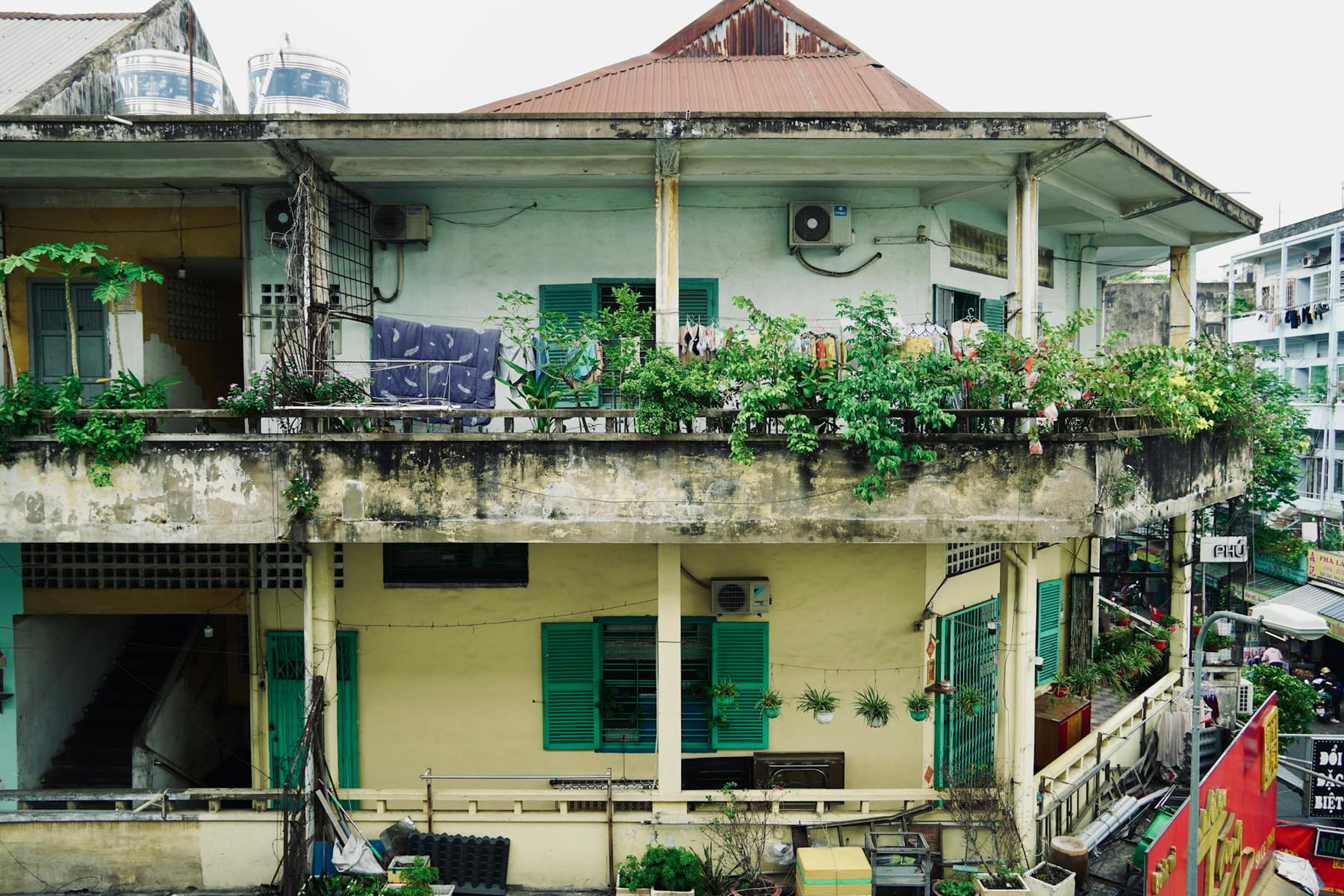 A city balcony adorned with lush plants in an urban residential area. on Urban Sprout Corner