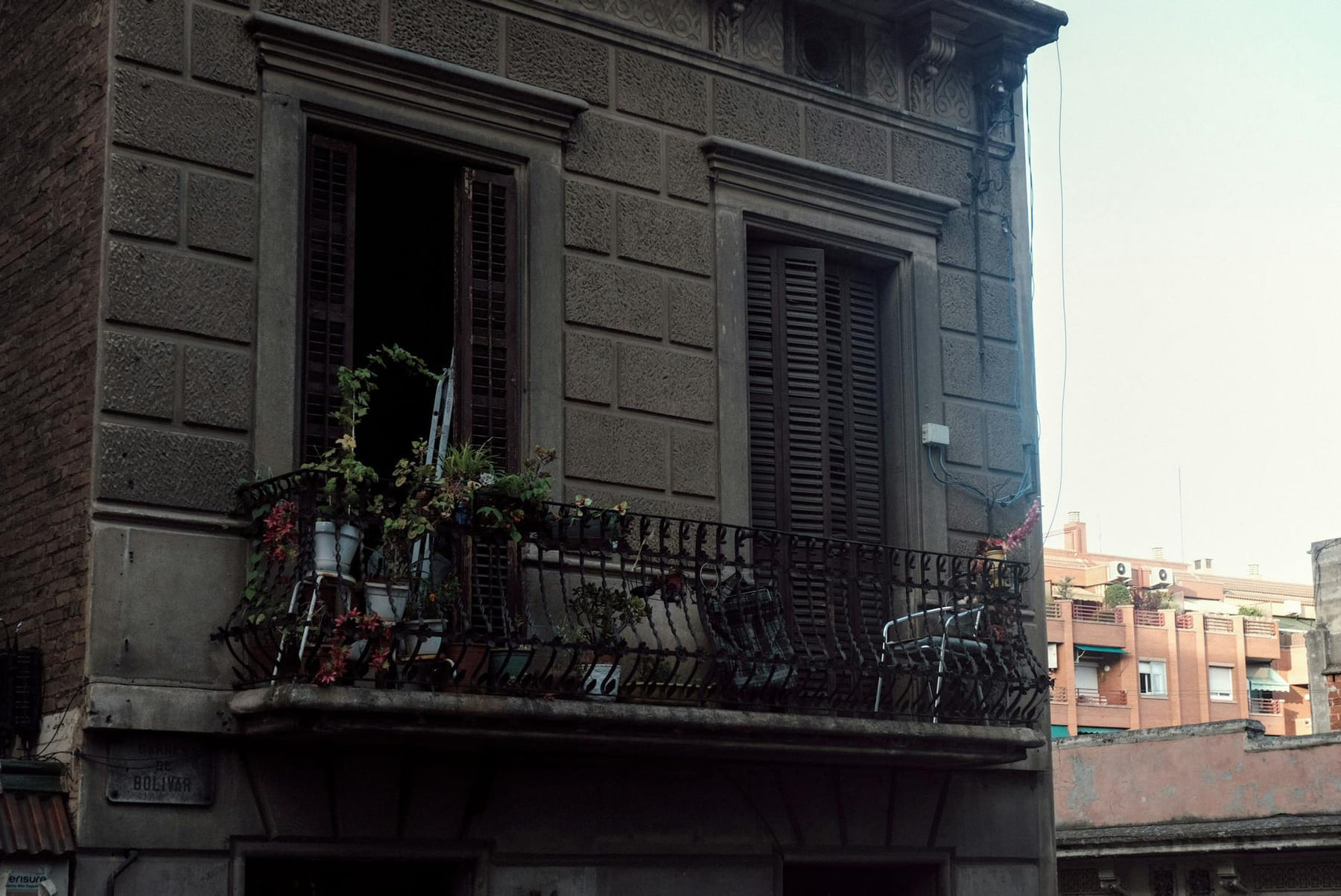 Rustic balcony with plants on an old townhouse facade in Barcelona, Spain. on Urban Sprout Corner